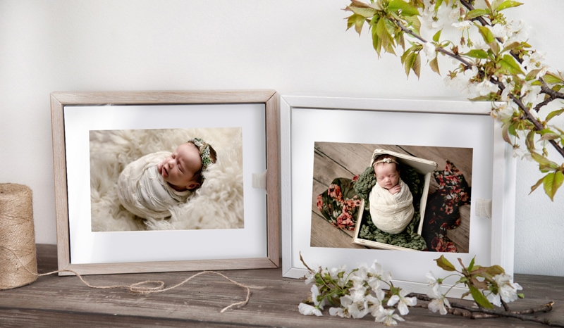 Box of matted prints of a newborn session.