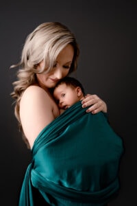 Mom wrapped with newborn boy. Cheat Lake photographer for newborns