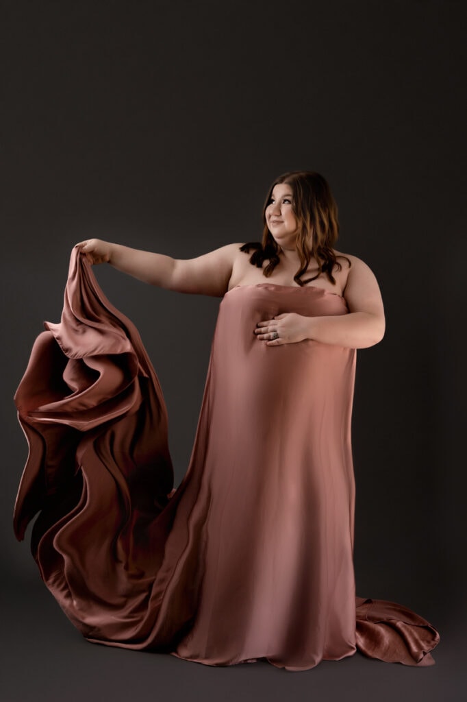 Expectant mom in studio with a draping fabric in silk. studio maternity session in Morgantown, wv
