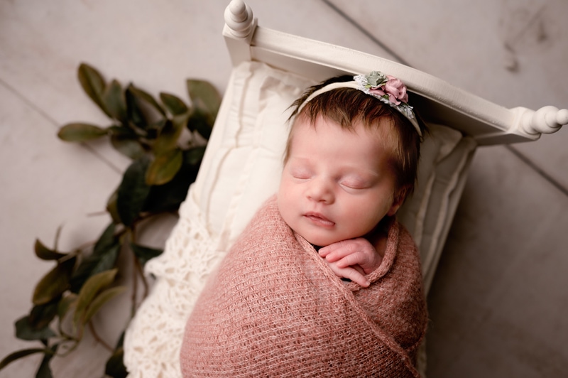 newborn girl with greenery. Smithtown photographer for newborns