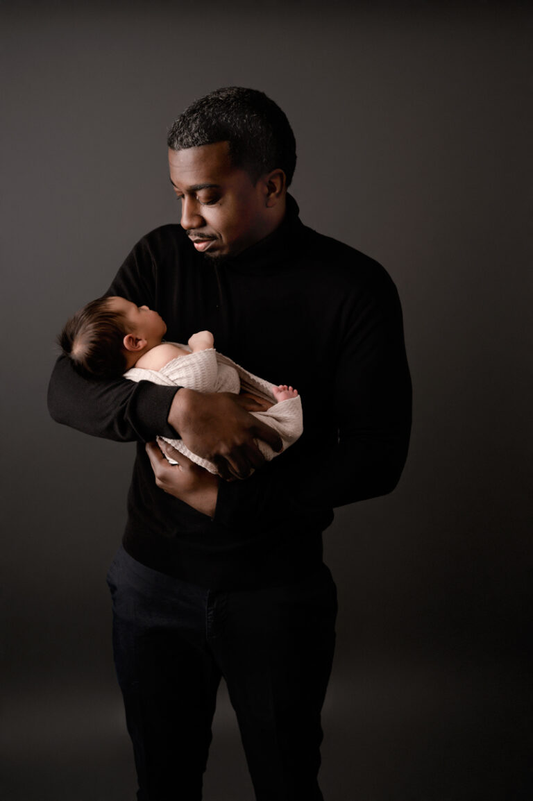 Dad holding his newborn baby boy. Newborn photography studio for Pittsburgh