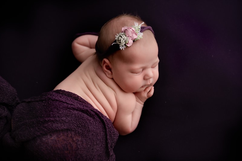 Newborn girl all in purple